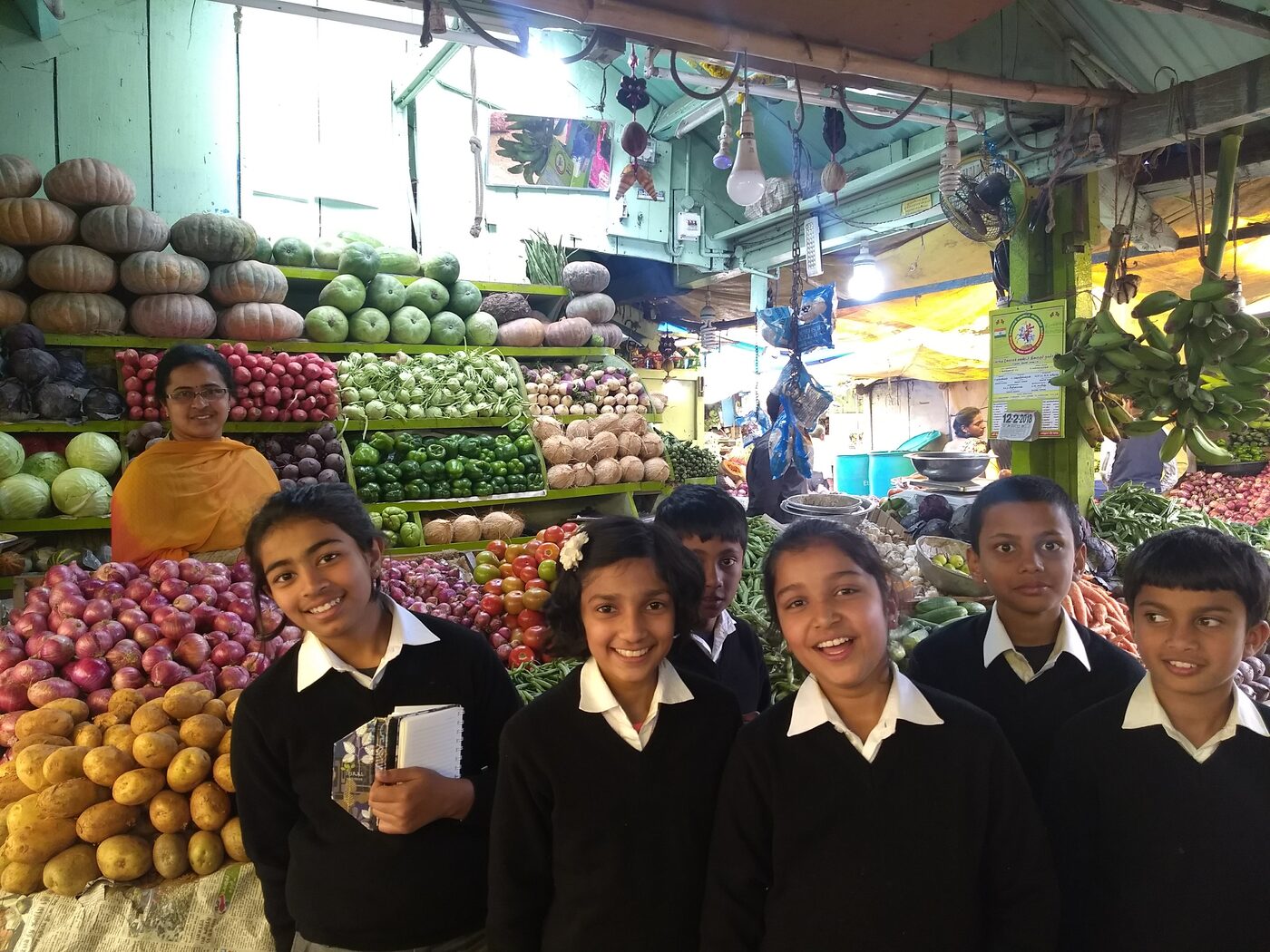 Grade 5 at a vegetable stall in Ooty's market